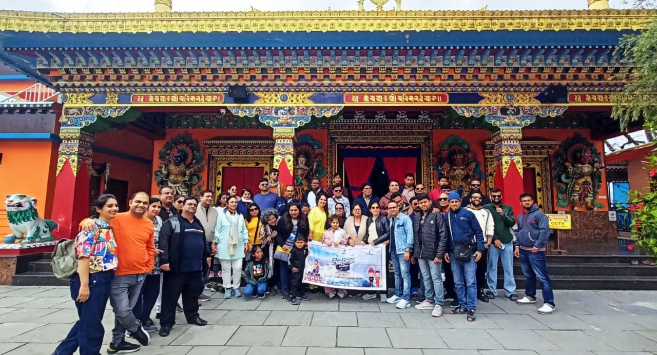 Client incentive trip group at a Bhutan monastery gate