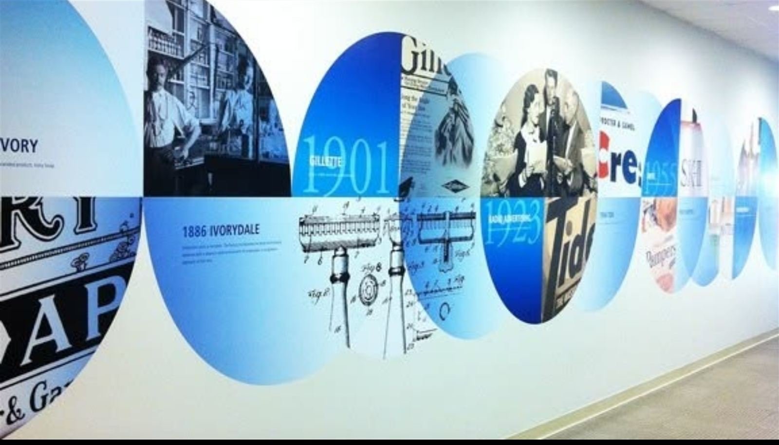 Circular brand heritage display wall installation
